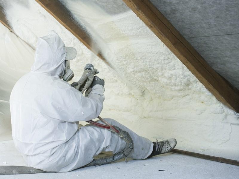 spraying insulation in attic