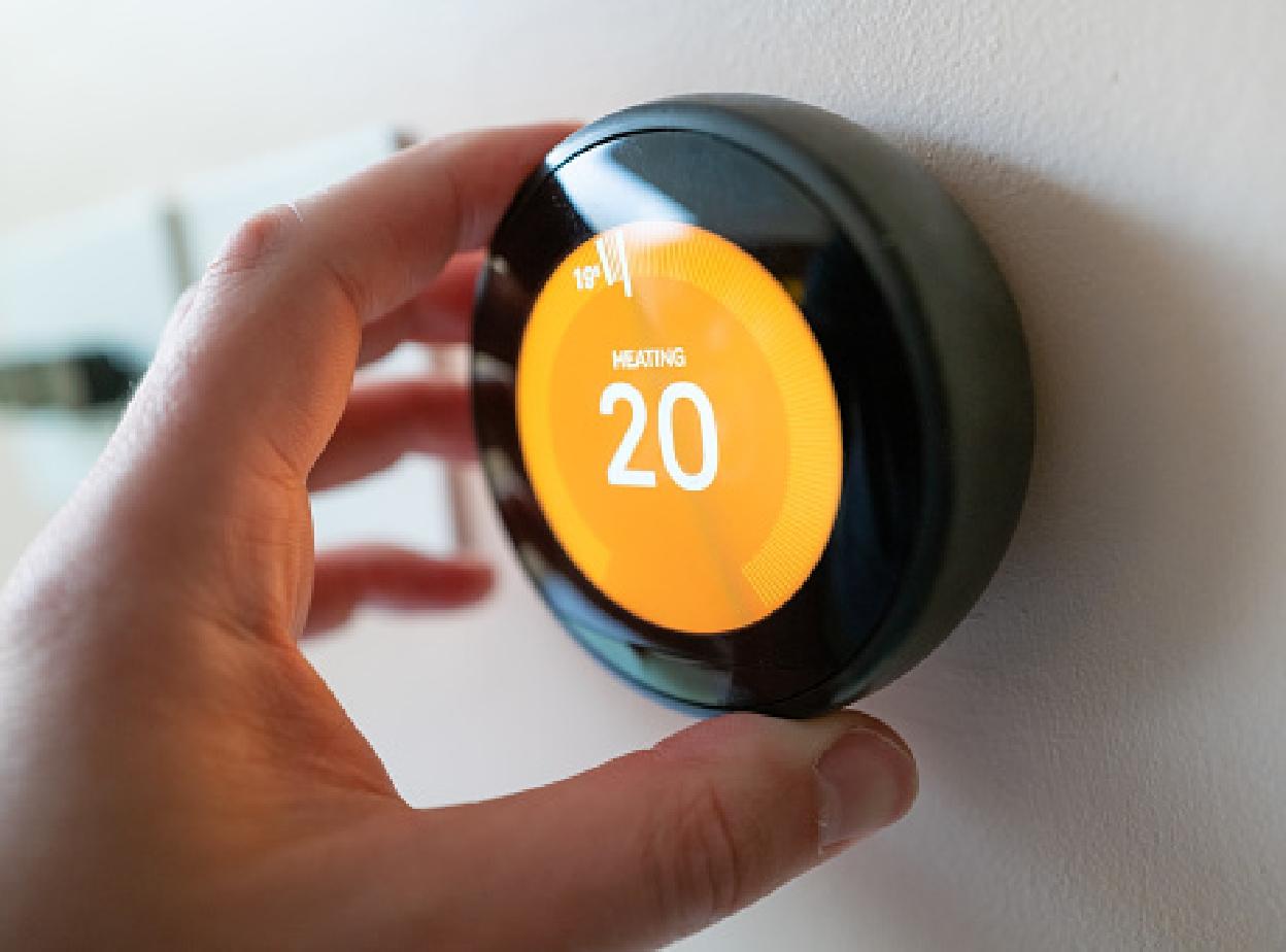 Hand adjusting NEST thermostat